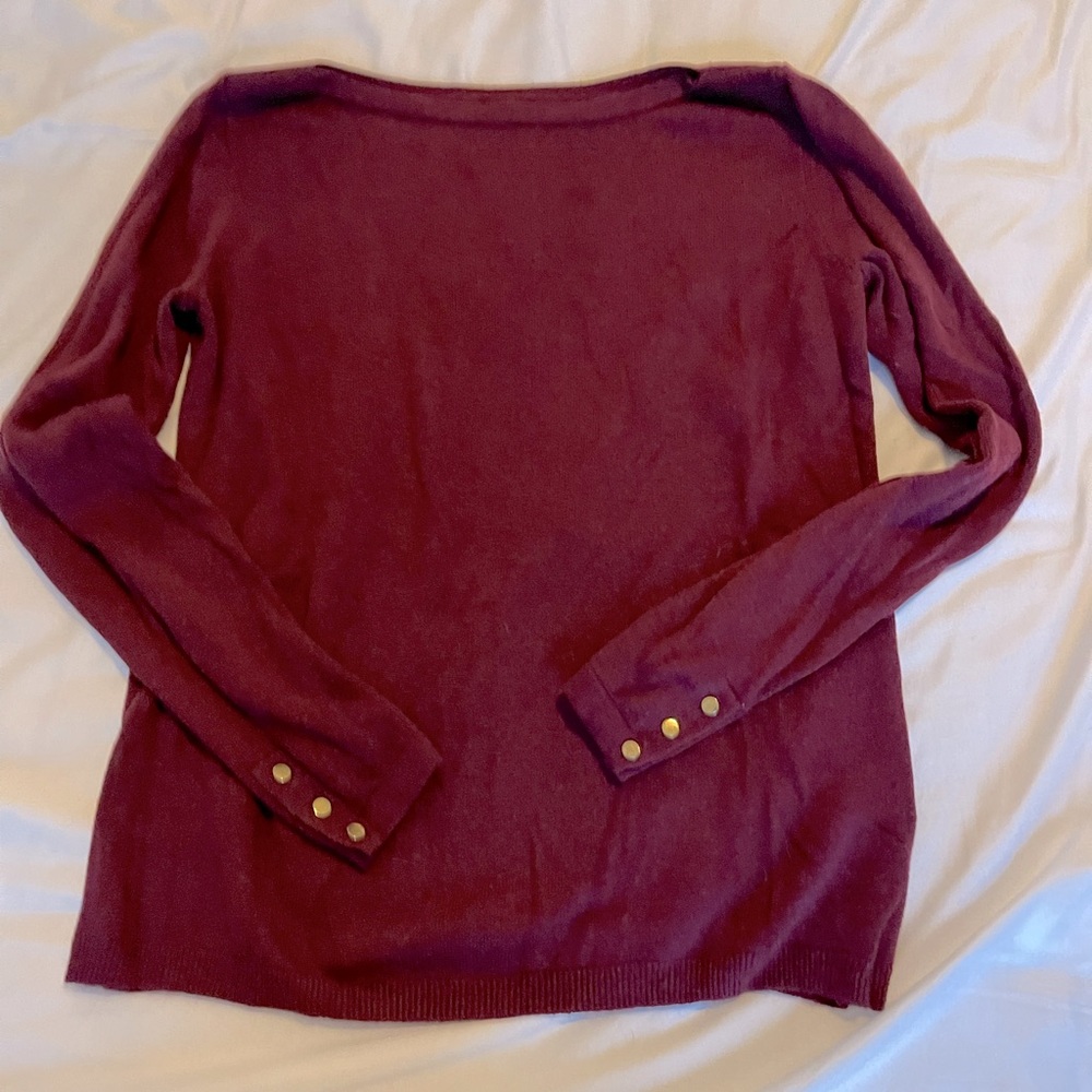 Maroon sweater with gold accents on sleeves